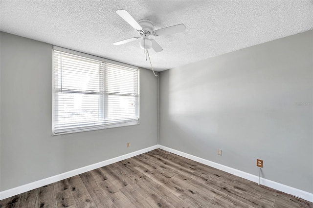4915 Bay St NE Unit 123, Saint Petersburg, FL 33703 - empty room with ceiling fan, a healthy amount of sunlight, and a textured ceiling