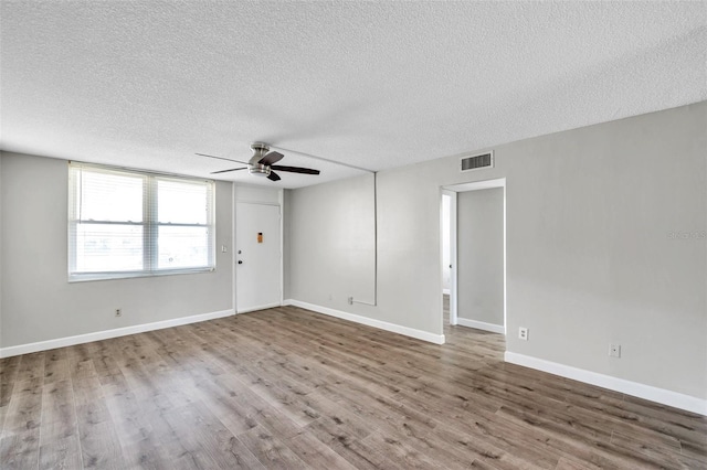 4915 Bay St NE Unit 123, Saint Petersburg, FL 33703 - empty room featuring hardwood / wood-style floors, ceiling fan, and a textured ceiling
