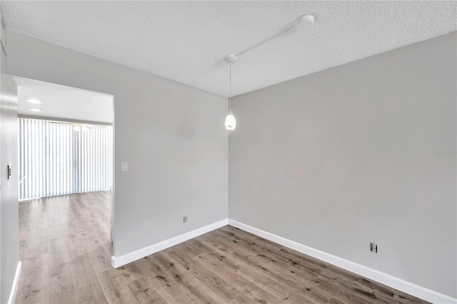 4915 Bay St NE Unit 123, Saint Petersburg, FL 33703 - unfurnished room with a textured ceiling and hardwood / wood-style flooring