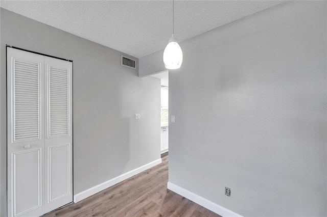 4915 Bay St NE Unit 123, Saint Petersburg, FL 33703 - unfurnished dining area with light wood-type flooring and a textured ceiling