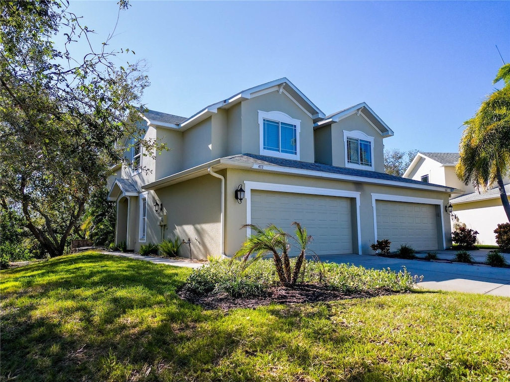 view of front property with a garage and a front lawn