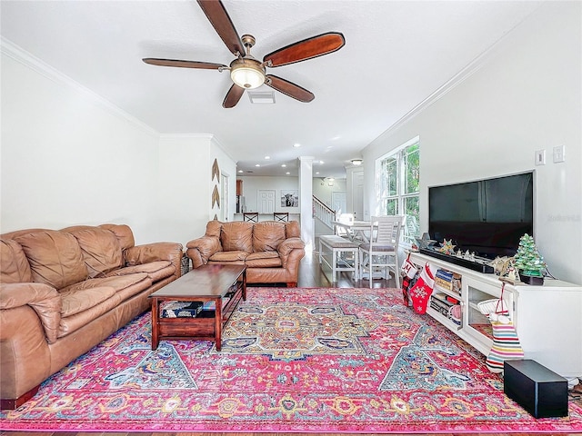 living room with ceiling fan and crown molding