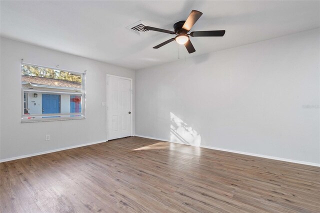 spare room featuring wood-type flooring and ceiling fan