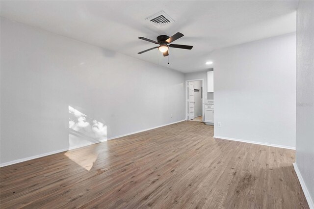 empty room with ceiling fan and wood-type flooring