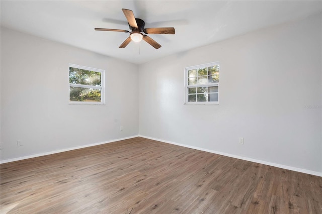 unfurnished room featuring hardwood / wood-style flooring, plenty of natural light, and ceiling fan