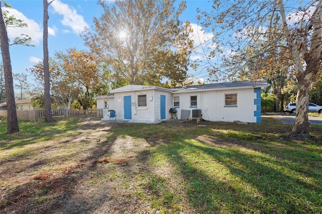 rear view of property featuring a yard