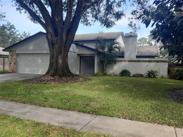 view of front of house with a front lawn and a garage