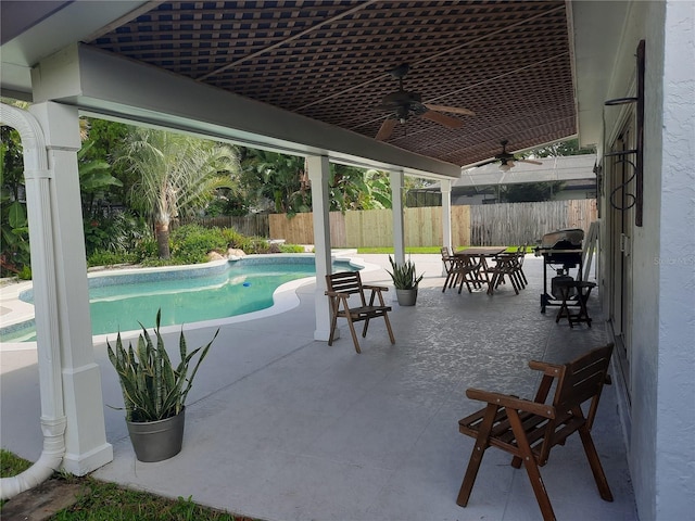 view of swimming pool with a patio and ceiling fan