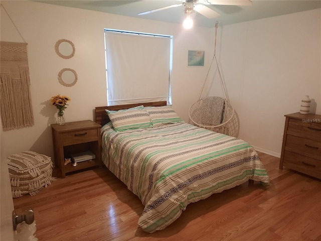 bedroom with ceiling fan and light hardwood / wood-style flooring