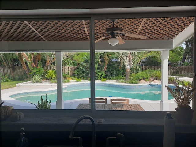 view of pool featuring ceiling fan and sink