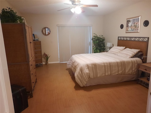 bedroom with ceiling fan and light hardwood / wood-style floors