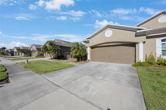 view of front of property with a garage and a front yard