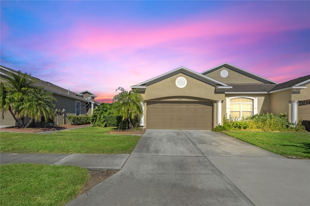 view of front of property with a lawn and a garage