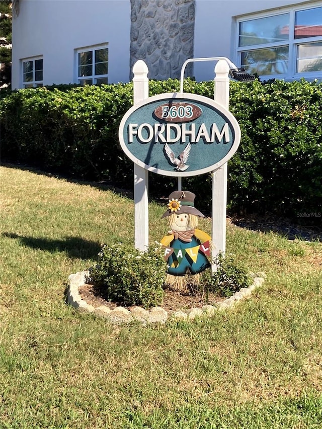 community / neighborhood sign with a lawn