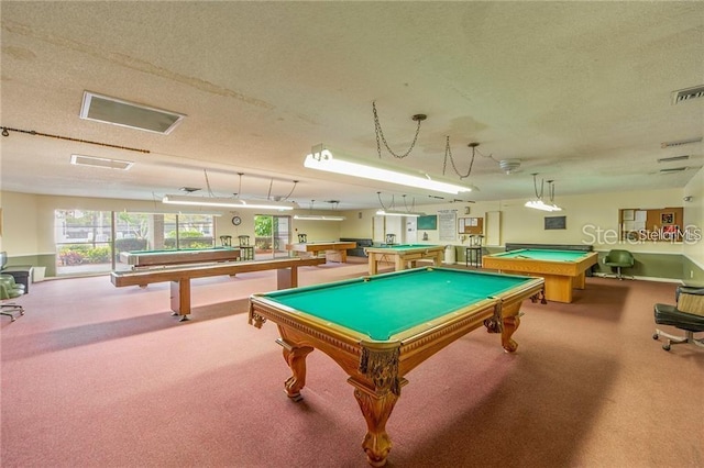 playroom with pool table, light colored carpet, and a textured ceiling