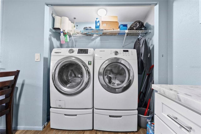 laundry room featuring light hardwood / wood-style flooring and washer and clothes dryer