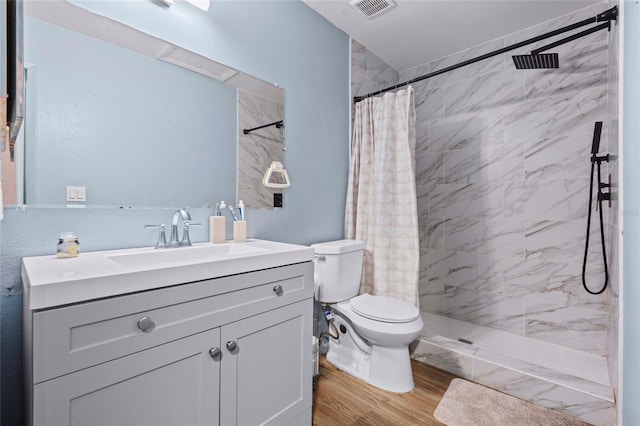 bathroom featuring a shower with curtain, vanity, wood-type flooring, and toilet