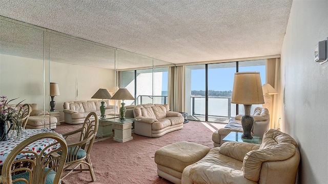 living room with carpet flooring, a textured ceiling, a water view, and expansive windows