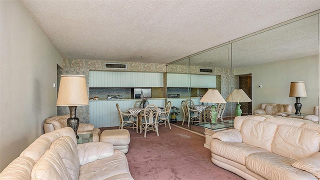 carpeted living room featuring a textured ceiling
