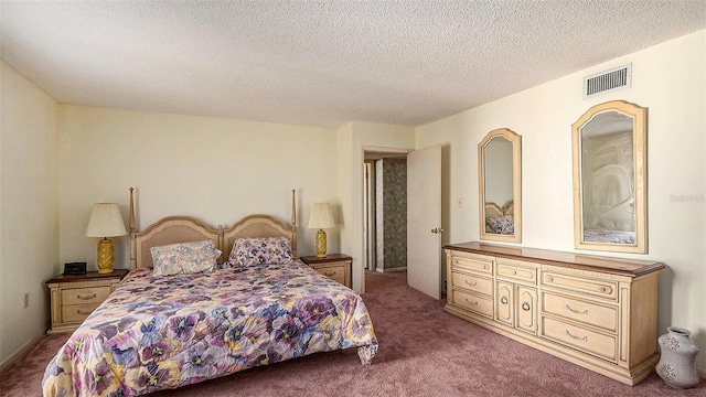 bedroom with carpet floors and a textured ceiling
