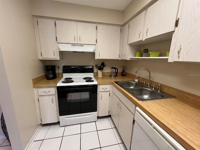 kitchen featuring sink, light tile patterned flooring, and white appliances