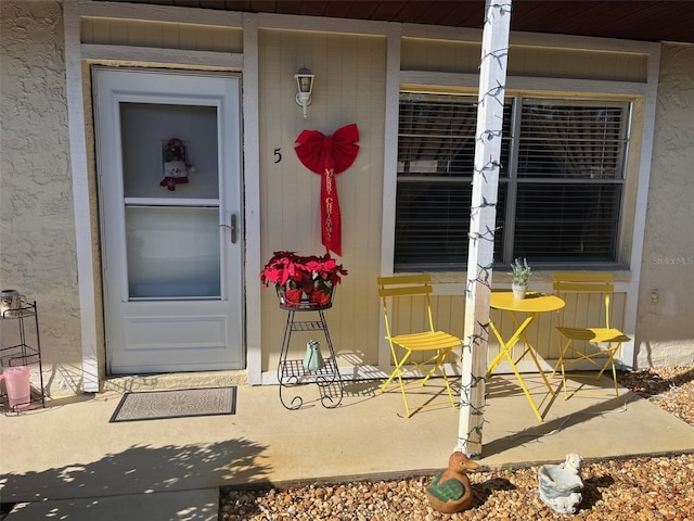 doorway to property with stucco siding