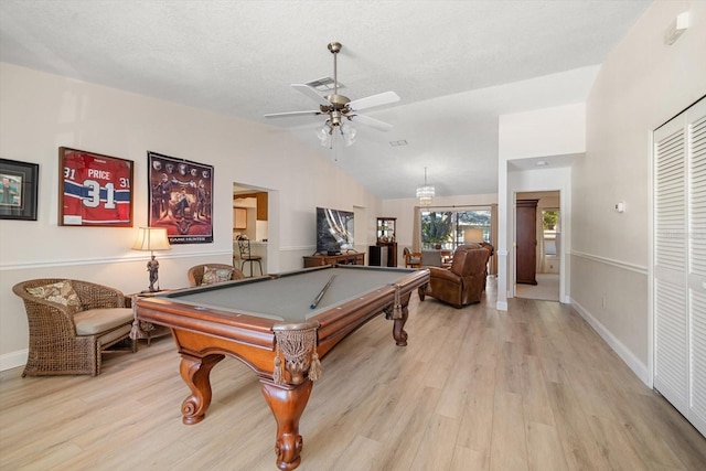 rec room featuring ceiling fan, billiards, a textured ceiling, lofted ceiling, and light wood-type flooring