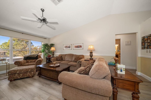 living room with ceiling fan, vaulted ceiling, and light hardwood / wood-style flooring