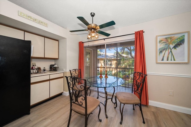 dining area with ceiling fan, a textured ceiling, and light hardwood / wood-style flooring