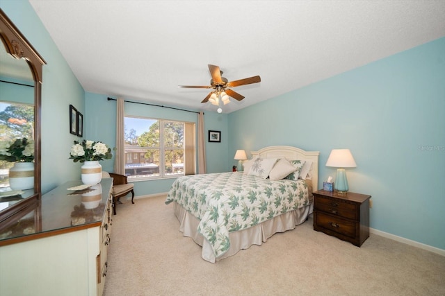 bedroom with ceiling fan and light colored carpet