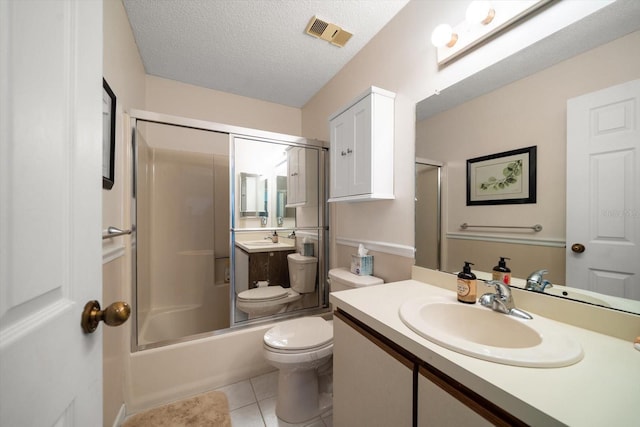 full bathroom featuring vanity, shower / bath combination with glass door, tile patterned floors, toilet, and a textured ceiling