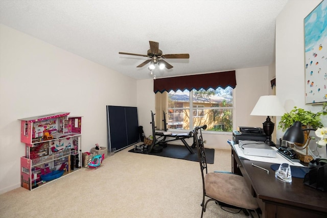 carpeted office space featuring a textured ceiling and ceiling fan