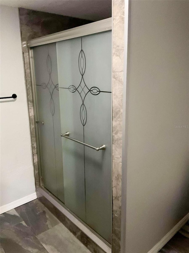 bathroom featuring a shower with shower door