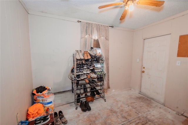 interior space with ceiling fan and a textured ceiling