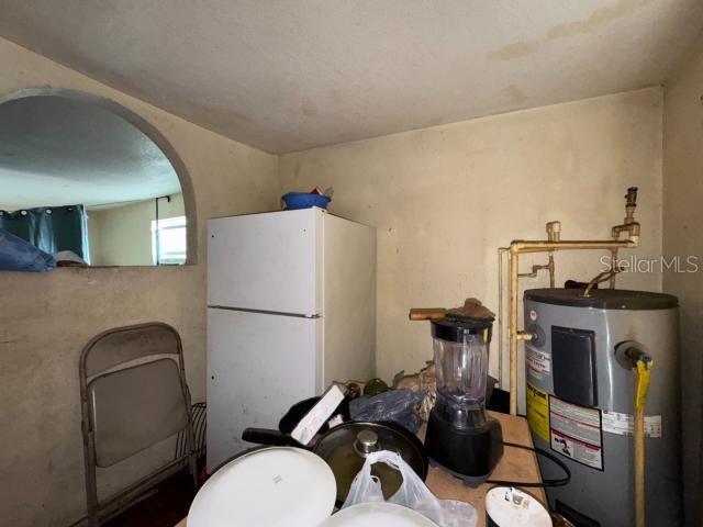 kitchen with water heater and white fridge