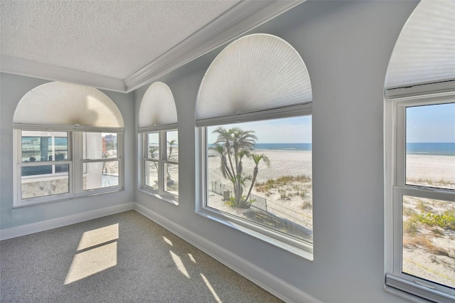 unfurnished sunroom with a water view and a healthy amount of sunlight