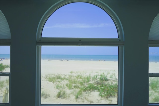 room details featuring a beach view and a water view