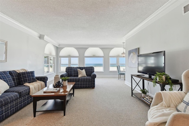 living area featuring crown molding, carpet flooring, a textured ceiling, and visible vents