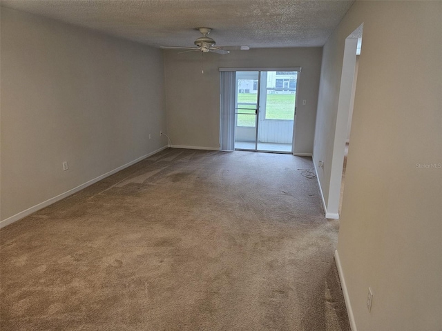 empty room with light carpet, ceiling fan, and a textured ceiling