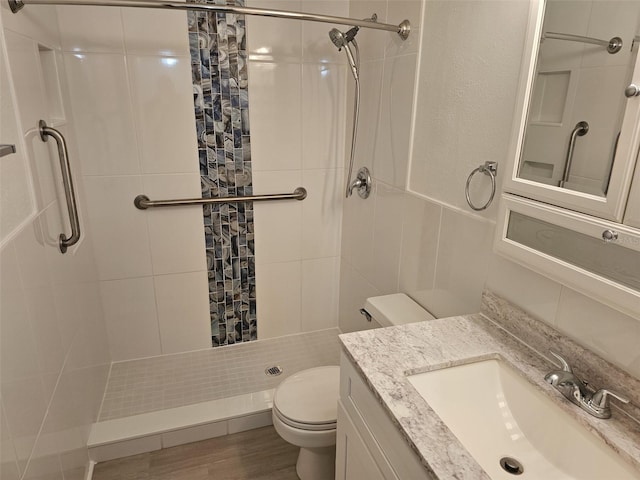 bathroom featuring curtained shower, hardwood / wood-style floors, vanity, and toilet