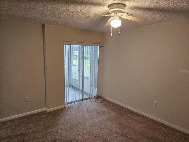 empty room featuring ceiling fan, carpet, and a textured ceiling