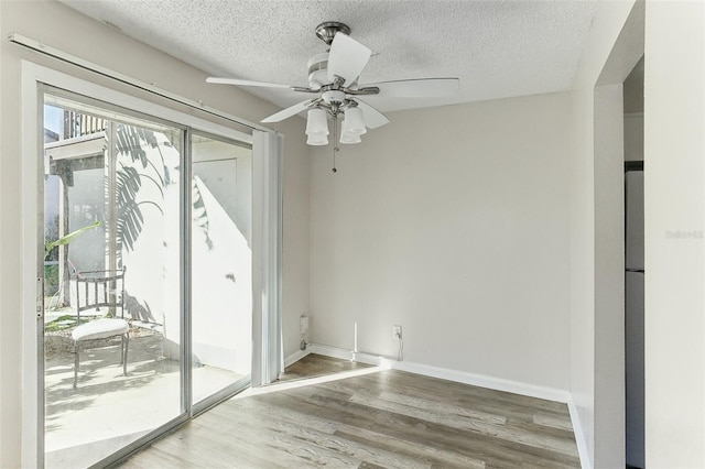 unfurnished room featuring hardwood / wood-style floors, a textured ceiling, and ceiling fan