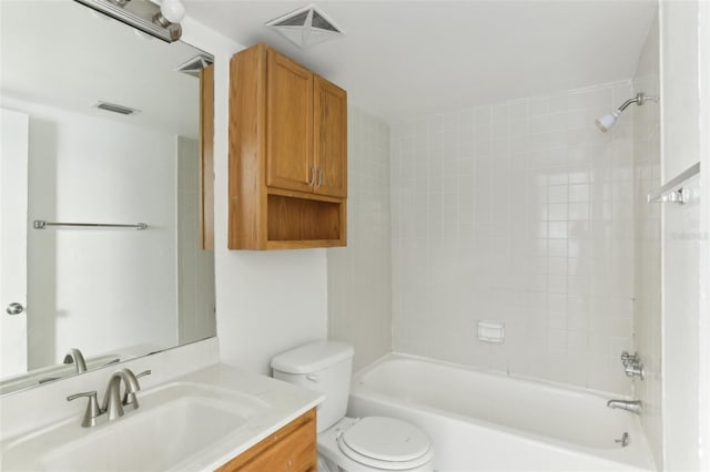 full bathroom featuring toilet, vanity, and tiled shower / bath combo