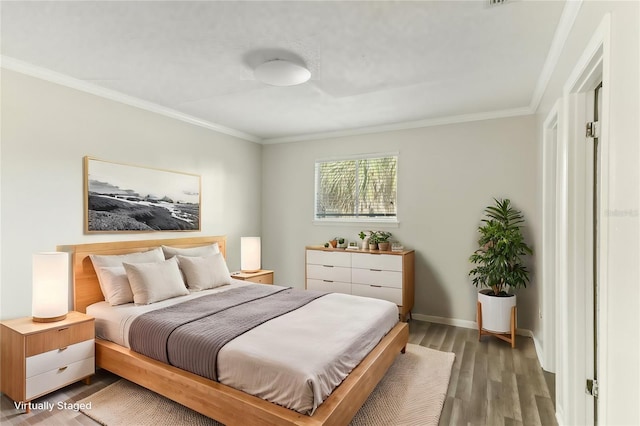 bedroom with wood-type flooring and crown molding