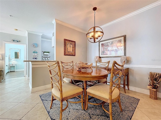 dining room with a notable chandelier, ornamental molding, a textured ceiling, and light tile patterned floors