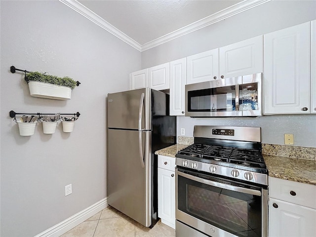 kitchen featuring white cabinets, light tile patterned flooring, crown molding, and appliances with stainless steel finishes