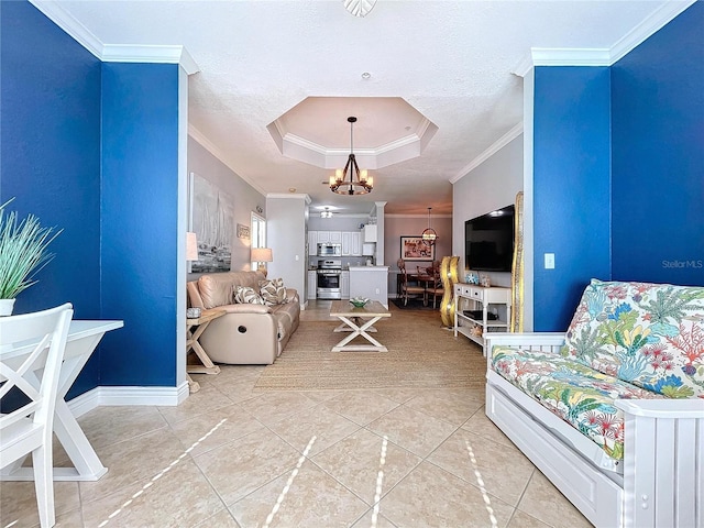 living room featuring a raised ceiling, tile patterned flooring, a textured ceiling, ceiling fan with notable chandelier, and ornamental molding