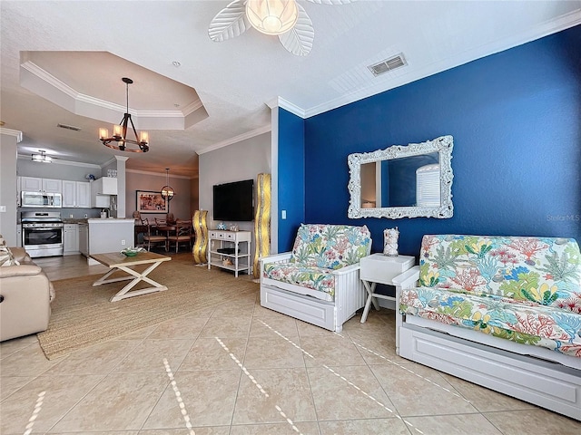 living room with a raised ceiling, light tile patterned floors, ceiling fan with notable chandelier, and ornamental molding