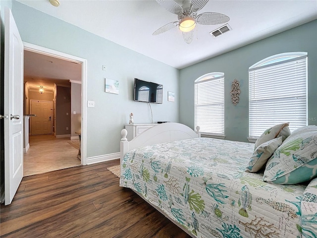 bedroom with ceiling fan and dark wood-type flooring