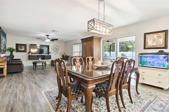 dining room with ceiling fan and light wood-type flooring